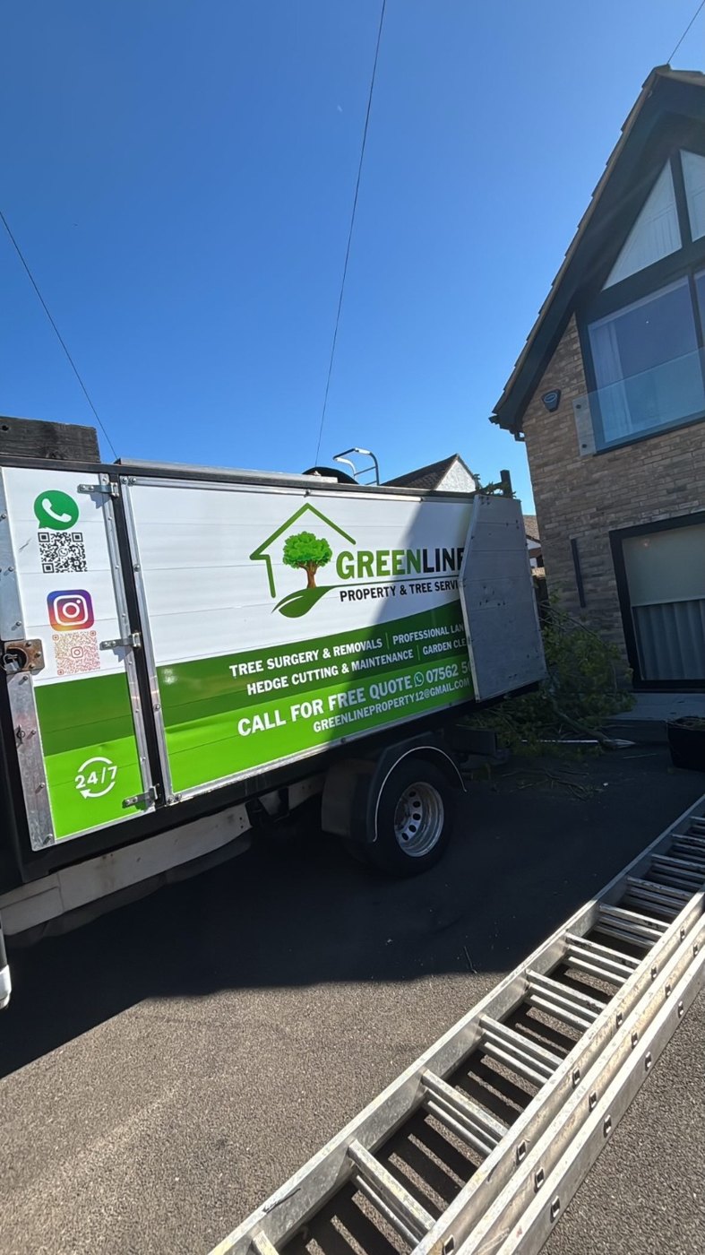 Greenline tipper truck parked outside a house during tree works