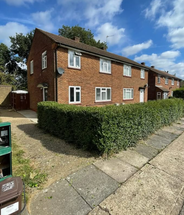 Semi-detached house with a freshly cut boundary hedge